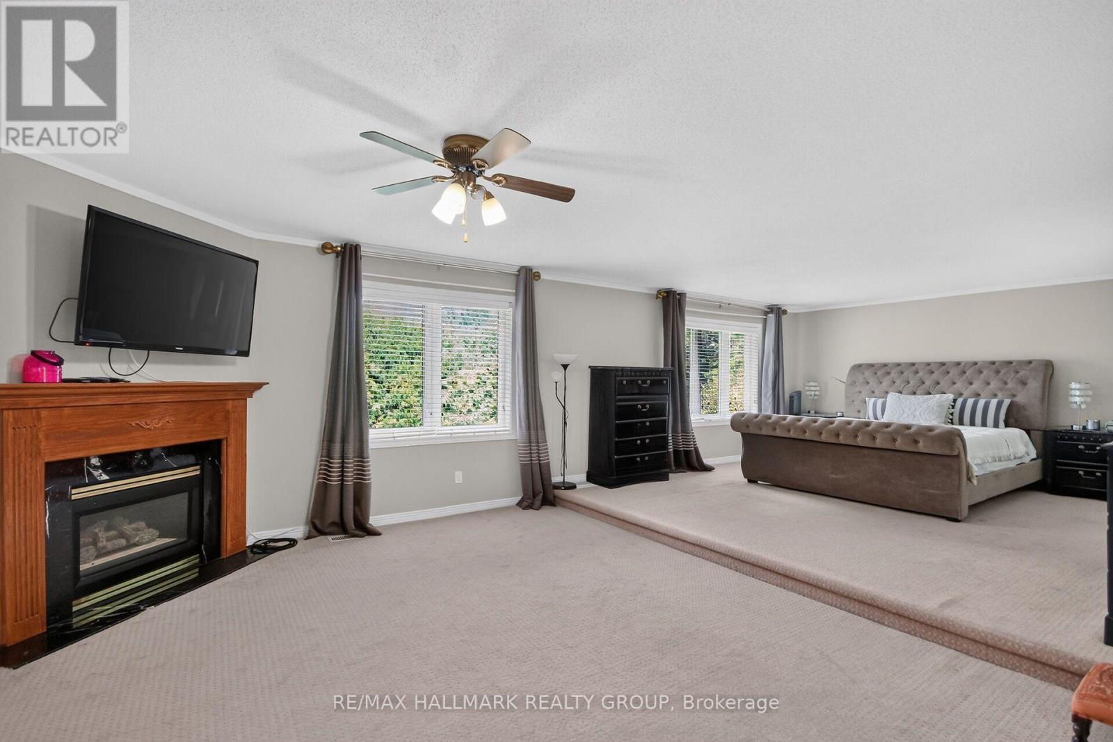 Primary bedroom has gas fireplace and sitting area - 11 Taj Court, Ottawa, ON