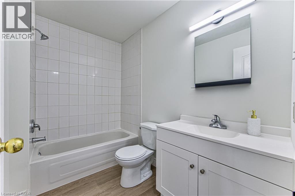 White tile-surround bathtub and shower combination - 168 Copper Leaf Street, Kitchener, ON
