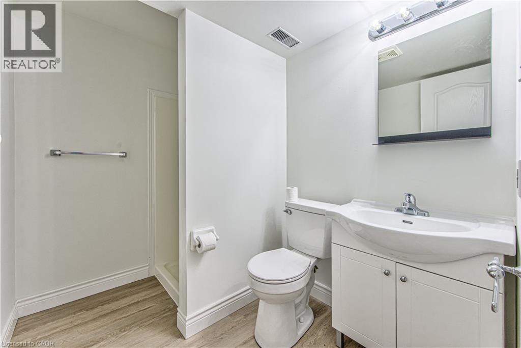 Wood-finish flooring with a toilet, vanity, and shower stall - 168 Copper Leaf Street, Kitchener, ON