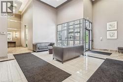 Two-story foyer with a paneled accent wall, recessed lighting, and a windowed entryway - 