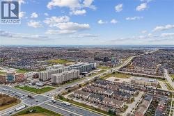 Expansive neighborhood with diverse residential structures, multiple commercial buildings, and arterial roadways - 