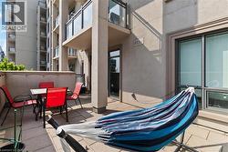 Private outdoor patio with stone paver flooring, stucco exterior, and sliding glass door access - 