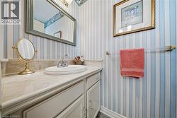 Vanity with an integrated oval sink, polished chrome faucet, and a stone-finish countertop - 