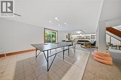 Recessed lighting, wood-finish trim, sliding glass door, mixed flooring surfaces, and a built-in staircase - 