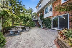 Expansive stamped concrete patio with direct outdoor access via a sliding glass door - 