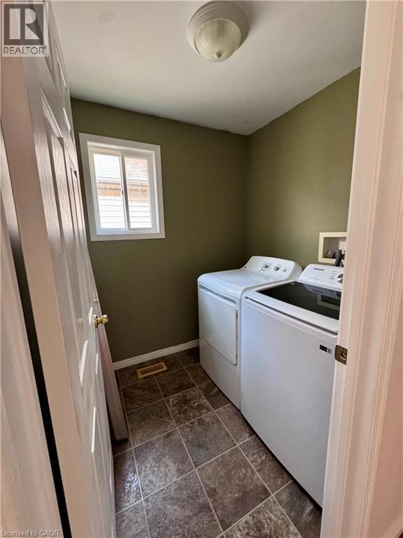 Dedicated laundry area featuring a window, tile flooring, and overhead lighting - 452 Beaumont Crescent, Kitchener, ON