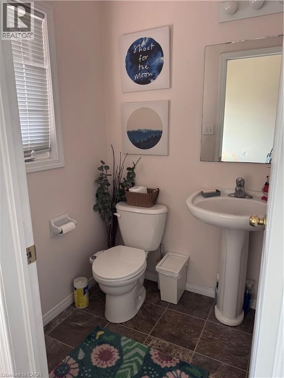 Bathroom featuring a pedestal sink, wall-mounted mirror, and tile flooring - 452 Beaumont Crescent, Kitchener, ON