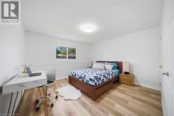 Room featuring light vinyl flooring, white walls, and a single window offering exterior views - 