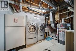 Dedicated laundry area featuring front-loading washer and dryer units - 