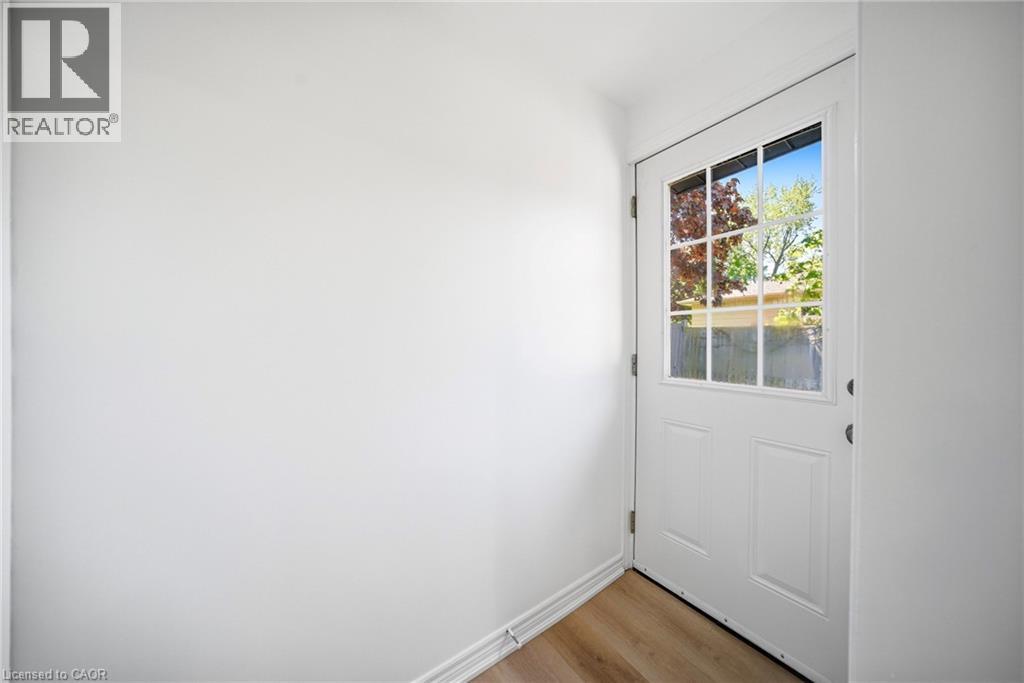 White paneled door with grid-patterned glass insert - 2306 Devon Road, Oakville, ON