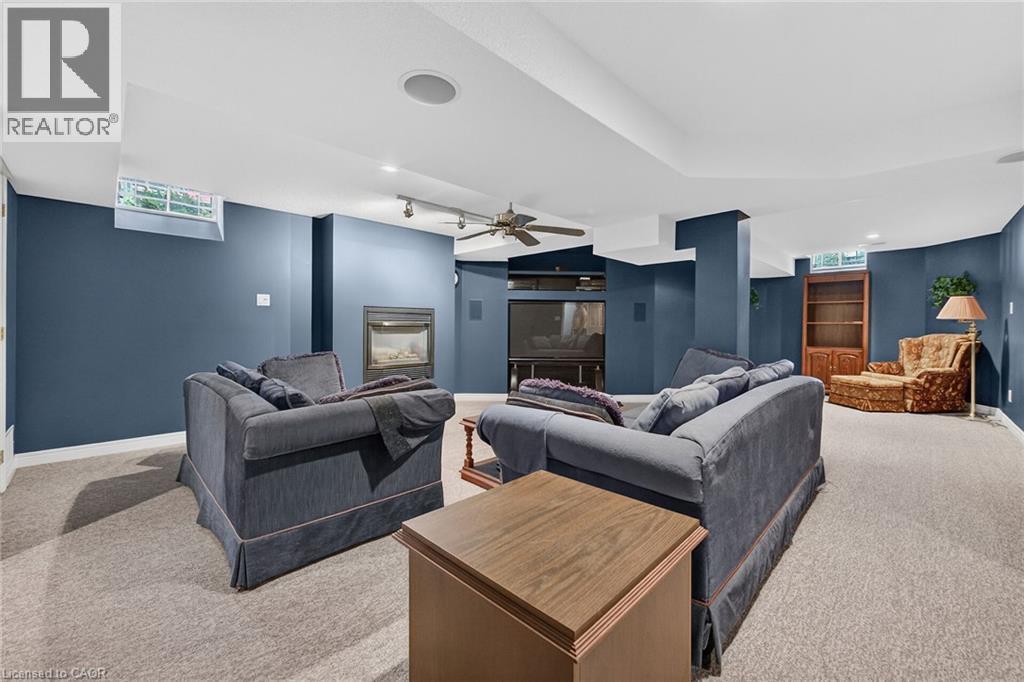 Spacious lower-level rec room featuring a gas fireplace and fan. - 159 Thoroughbred Boulevard, Ancaster, ON