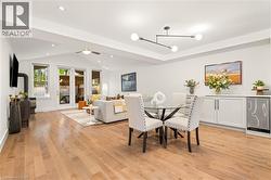 Hardwood flooring throughout, vaulted ceiling with recessed lighting, built-in cabinetry with counter space, and a wood-burning stove - 