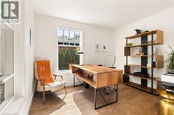 Wood-finish flooring, recessed lighting, and white trim - 
