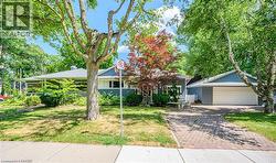 Single-story exterior with light blue siding, a covered front porch, and a white garage door - 
