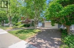 Cobblestone-style paver driveway leading to a two-car garage - 