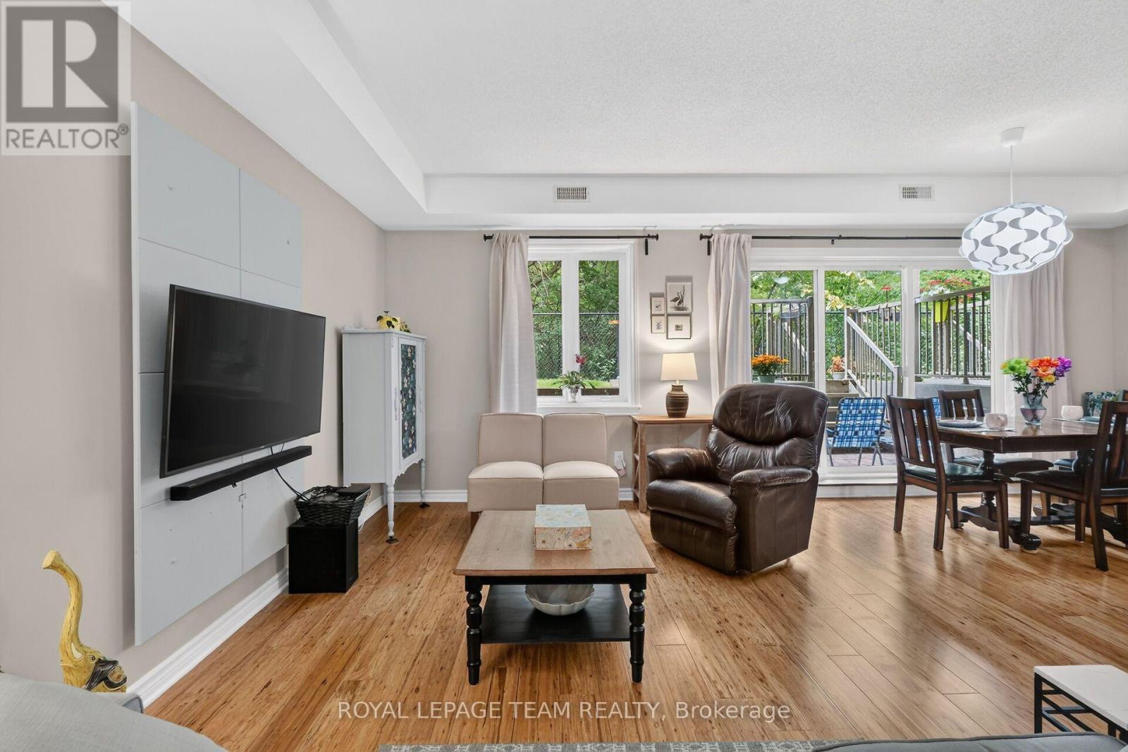 Large windows & patio doors flood area w/light. - B - 1004 Beryl Private, Ottawa, ON