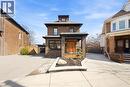 Brick facade residence with a prominent covered porch featuring an orange double entry door - 273 Stinson Crescent, Hamilton, ON 