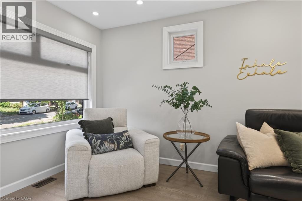 Recessed lighting illuminates an interior space featuring wood-finish flooring - 273 Stinson Crescent, Hamilton, ON