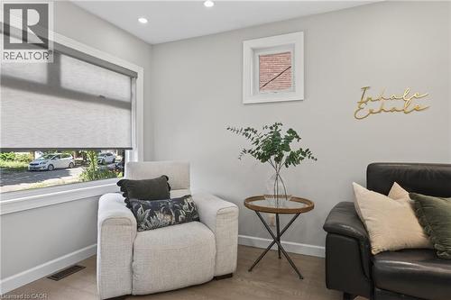 Recessed lighting illuminates an interior space featuring wood-finish flooring - 273 Stinson Crescent, Hamilton, ON 