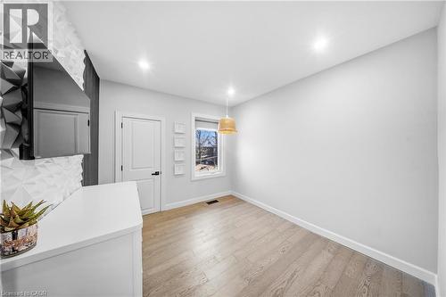 Unfurnished dining area featuring baseboards and light wood finished floors - 273 Stinson Crescent, Hamilton, ON 