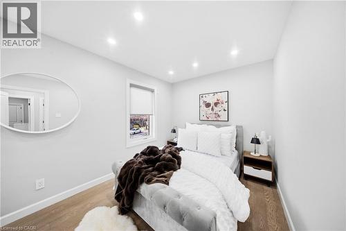 Bedroom with wood finished floors and recessed lighting - 273 Stinson Crescent, Hamilton, ON 