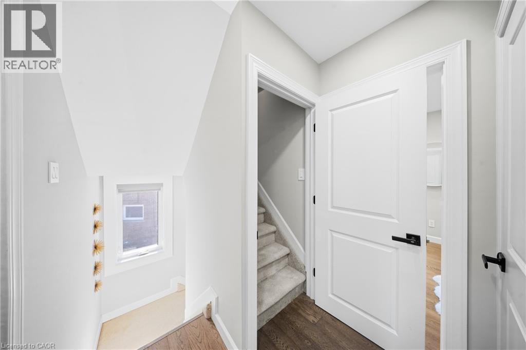 Stairs featuring wood finished floors and baseboards - 273 Stinson Crescent, Hamilton, ON