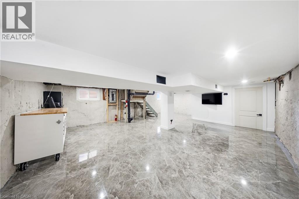 Below grade area with light marble finish flooring and electric panel - 273 Stinson Crescent, Hamilton, ON