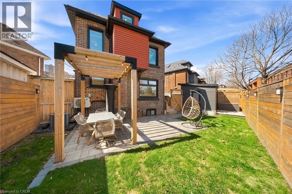 Back of house featuring a fenced backyard, brick siding, a patio area, and a pergola - 273 Stinson Crescent, Hamilton, ON