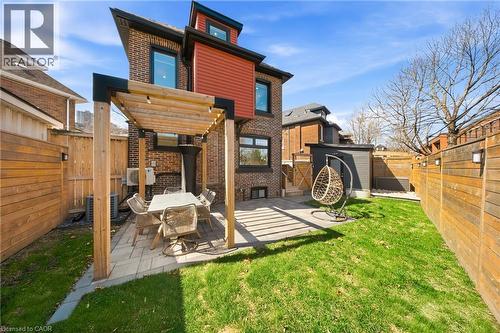 Back of house featuring a fenced backyard, brick siding, a patio area, and a pergola - 273 Stinson Crescent, Hamilton, ON 