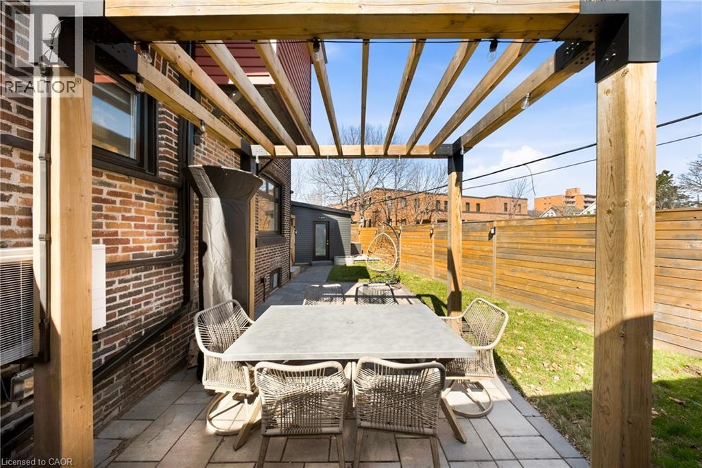 Fenced backyard with a pergola, a patio, and outdoor dining area - 273 Stinson Crescent, Hamilton, ON