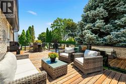 Expansive outdoor deck featuring wood-finish flooring and glass panel railings -