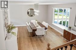 Light wood-finish flooring, recessed lighting, and a bay window with a built-in window bench -