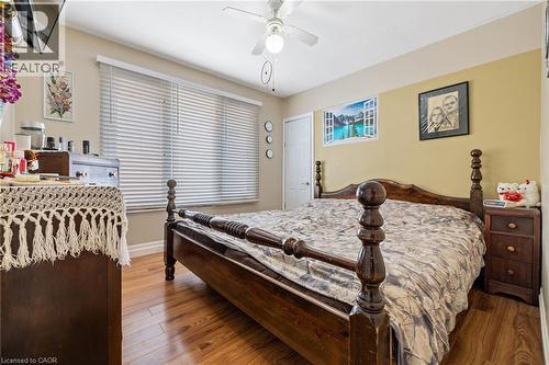 Wood-finish flooring with a ceiling fan light fixture - 625 Tate Avenue, Hamilton, ON 