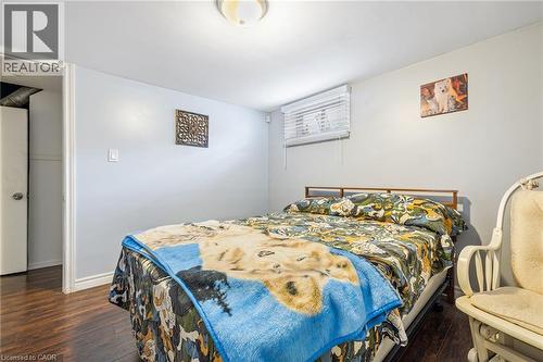 Wood-finish flooring with light-toned walls and a flush-mount ceiling fixture - 625 Tate Avenue, Hamilton, ON 