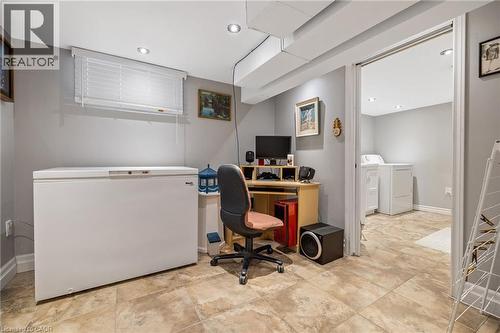 Recessed lighting and a window with blinds illuminate this versatile space, featuring neutral wall tones and tile flooring - 625 Tate Avenue, Hamilton, ON 