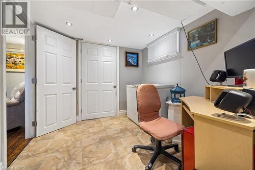 Recessed lighting illuminates the space, featuring durable tile flooring and a window with blinds - 625 Tate Avenue, Hamilton, ON 