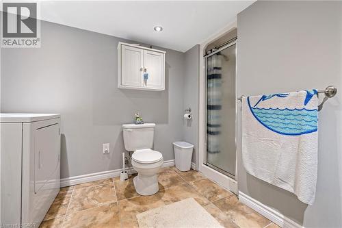 Recessed ceiling lighting, tiled flooring, built-in wall cabinet, glass-enclosed shower, and a towel bar - 625 Tate Avenue, Hamilton, ON 