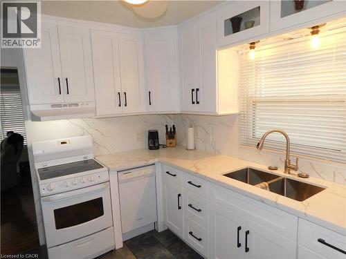 White shaker-style cabinetry with matte black hardware - 625 Tate Avenue, Hamilton, ON 