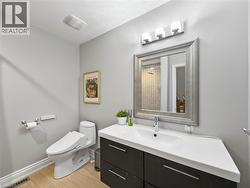 Modern vanity with integrated sink, three-light fixture, framed mirror, and wood-finish flooring - 