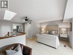 Carpeted bedroom with a vaulted ceiling and skylight - 