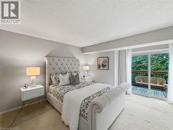 Recessed lighting, light-colored carpeting, sliding glass door, and a private balcony with railing - 