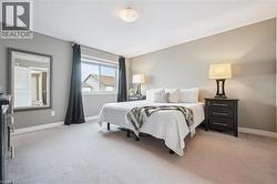Plush carpet flooring, neutral paint, a large window, and a flush-mount ceiling light fixture - 