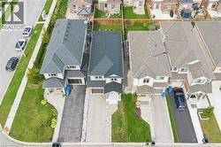 Traditional-style residence with a dark gray shingle roof and a two-car garage - 