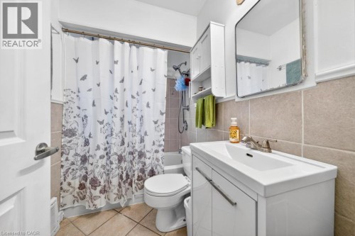 Vanity with integrated sink, chrome faucet, and storage cabinetry - 420 Upper Gage Avenue, Hamilton, ON 