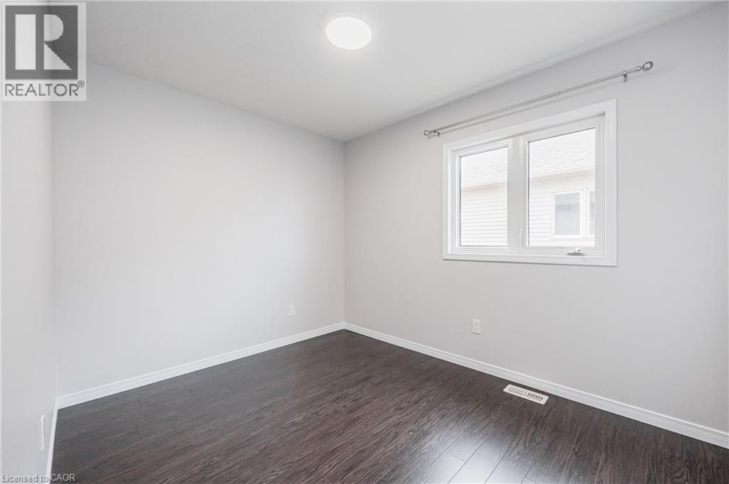 Recessed ceiling lighting, wood-finish flooring, white walls, white trim, and a white framed window - 224 Jessica Crescent Unit# B, Kitchener, ON