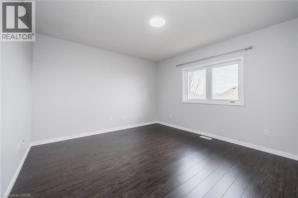 Recessed lighting, wood-finish flooring, white trim, and a window with a curtain rod - 224 Jessica Crescent Unit# B, Kitchener, ON