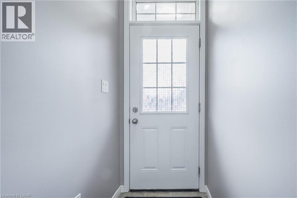 White paneled door with integrated glass panes and a transom window - 224 Jessica Crescent Unit# B, Kitchener, ON