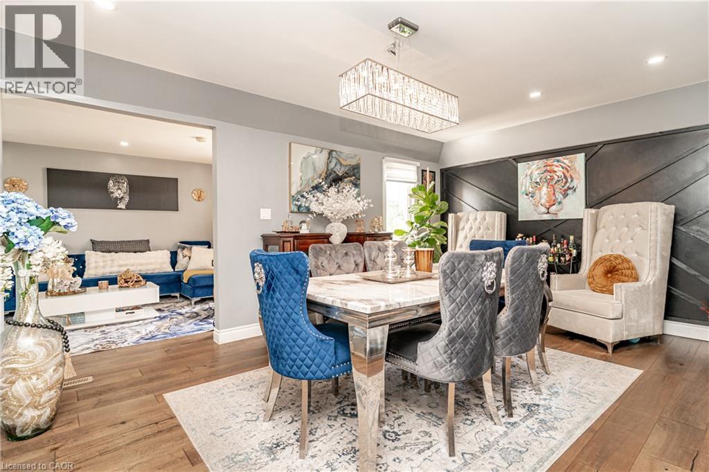 Wood-finish flooring throughout, recessed lighting, and a modern rectangular chandelier - 52 Charters Road, Brampton, ON