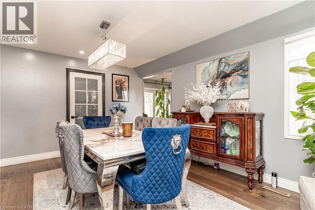 Hardwood-style flooring throughout, recessed lighting, and a modern rectangular crystal chandelier - 52 Charters Road, Brampton, ON