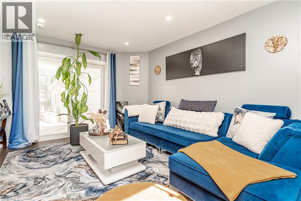 Recessed ceiling lighting, wood-finish flooring, and a sliding glass door providing outdoor access - 52 Charters Road, Brampton, ON